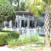 A large white gazebo sitting in the middle of a garden.
