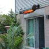 A patio heater hanging on the side of a building.