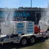 A trailer with two large buckets on it